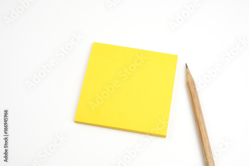 yellow sticky note with brown pencil