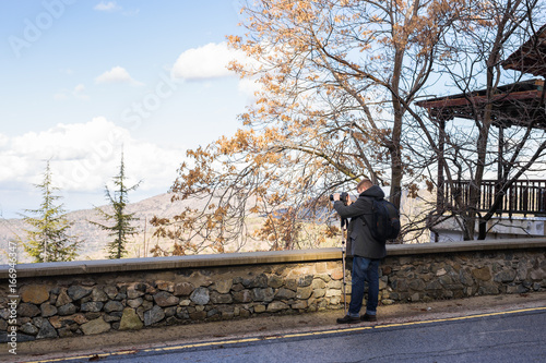 Traveler photographer with digital camera on the town