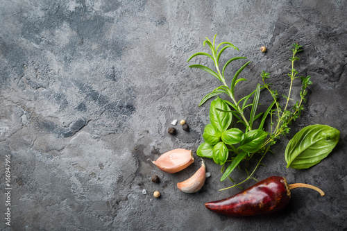 Fotografie Selectionof herbs and spices on stone background