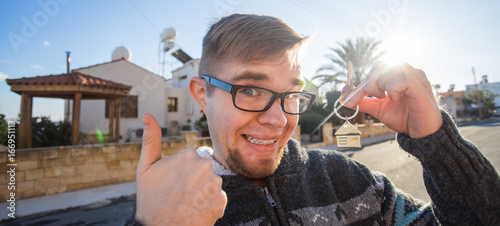 Property, ownership, new home and people concept - Young funny man moving into new home photo