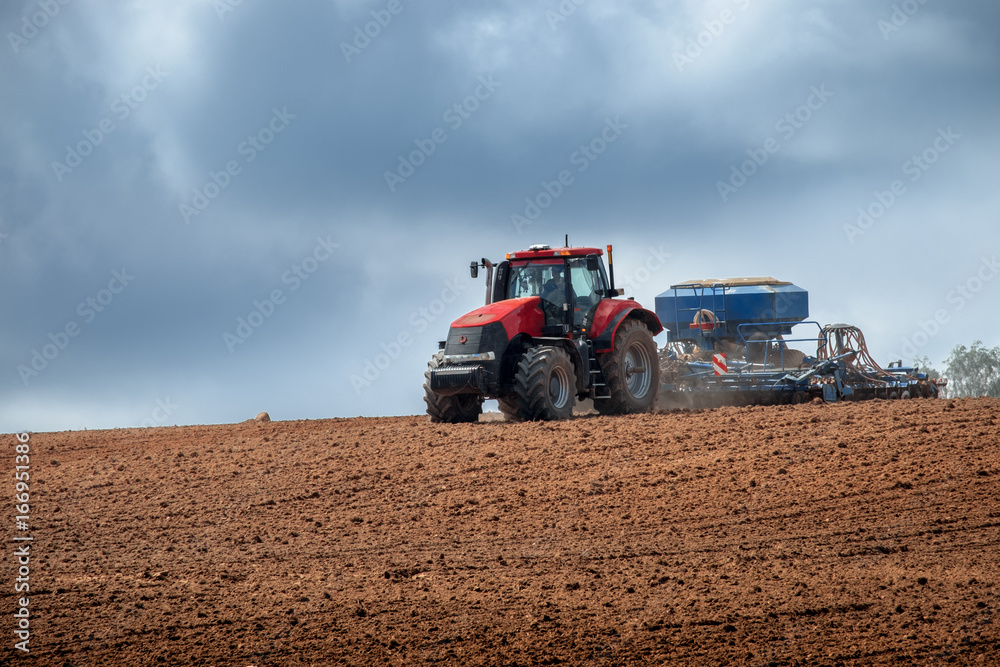 Fototapeta premium modern tractor in the agricultural field
