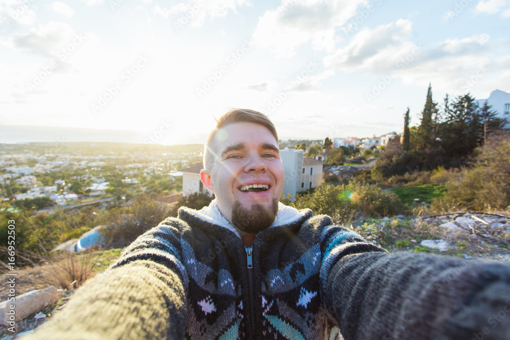 Handsome man is taking a selfie outdoor - caucasian people - nature, people, lifestyle and technology concept. Handsome man is taking a selfie outdoor - caucasian people - nature, people, lifestyle and technology concept.