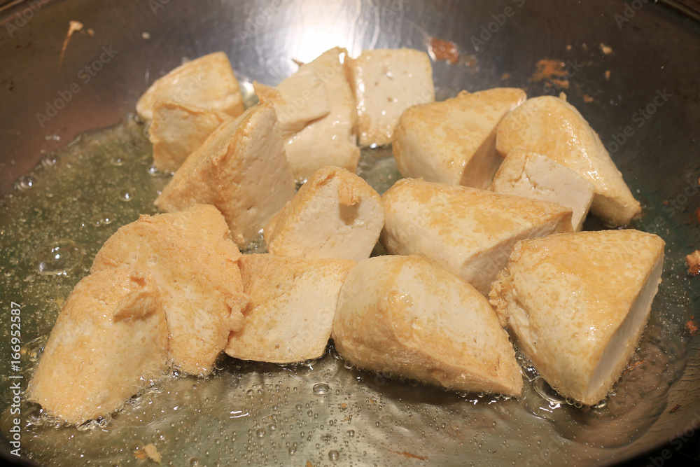 Cooking tofu fries in oil, The process of cooking frying pieces of Tofu on a special grill pan in the kitchen. Vegetarian dishes. Soy Tofu Grilled. Fried Tofu Recipe, Soft focus. Cooking tofu fries in oil, The process of cooking frying pieces of Tofu on a special grill pan in the kitchen. Vegetarian dishes. Soy Tofu Grilled. Fried Tofu Recipe, Soft focus.
