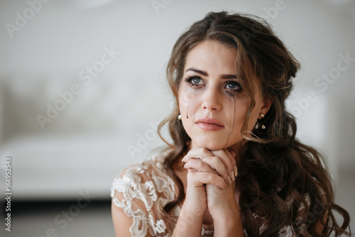 Fototapeta portrait of the bride crying, sadness, streaks mascara wipes