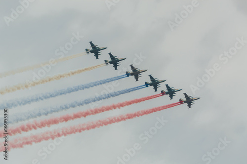 Russia, Saint-Petersburg, July 30, 2017, in celebration of the Navy, the flight of aircraft made out of the smoke a Russian flag over the city. photo