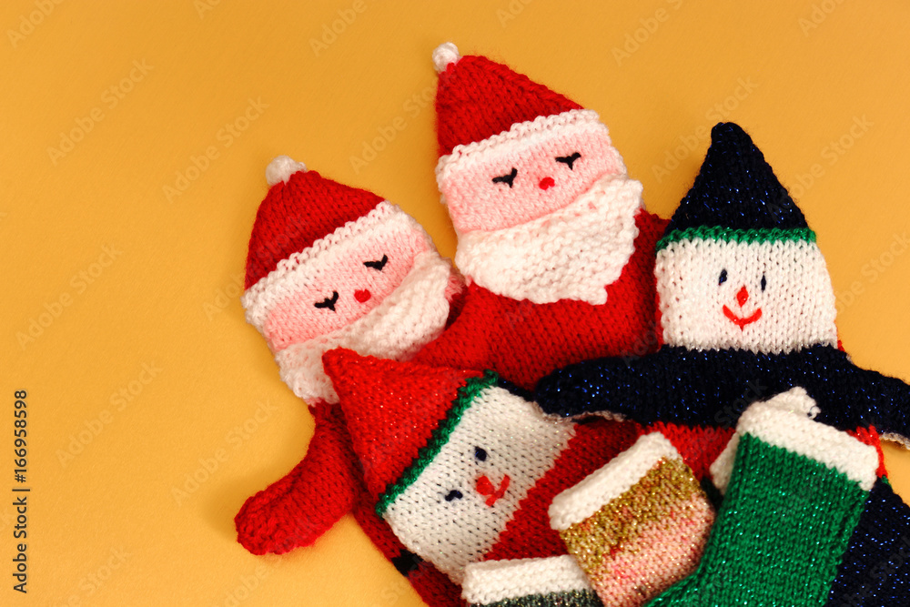 Knitted Father Christmas glove puppets and stockings on a gold background Knitted Father Christmas glove puppets and stockings on a gold background