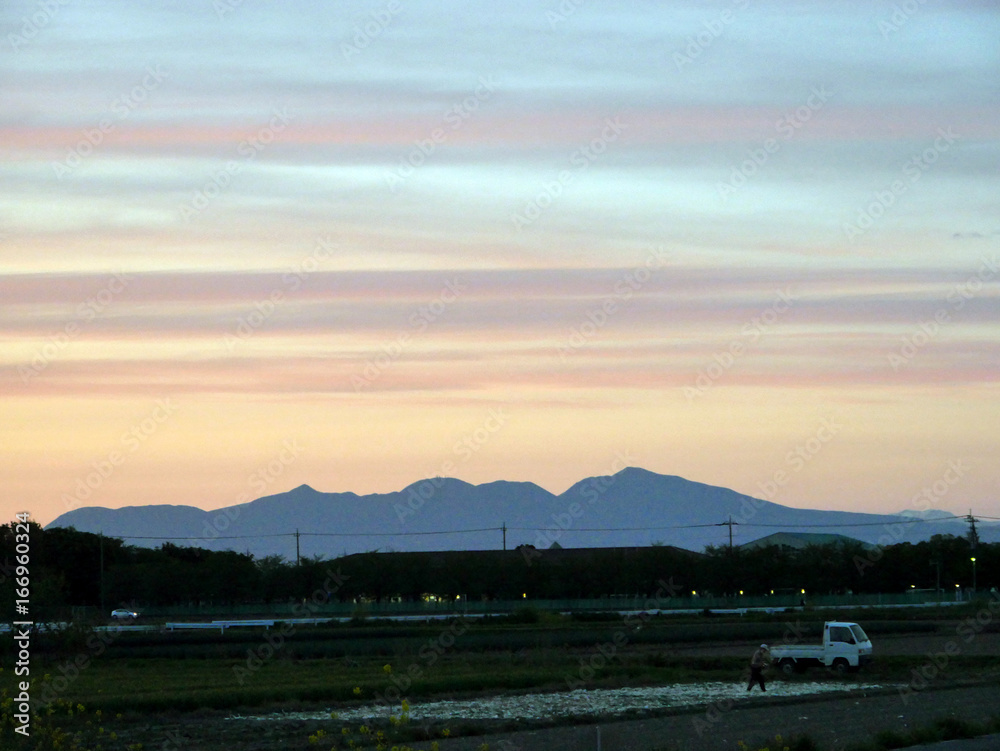 At dusk. Farmer works in the field. At dusk. Farmer works in the field.
