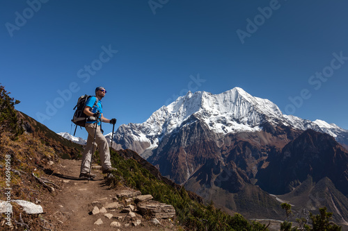 Hiker is climbig to Manaslu base camp in highlands of Himalayas on Manaslu circuit