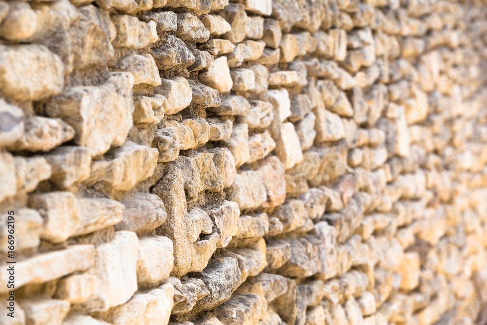 Wall of Field Stones / Closeup ancient natural wall of bright dry stones (focused and blurred part, copy space) Wall of Field Stones / Closeup ancient natural wall of bright dry stones (focused and blurred part, copy space)