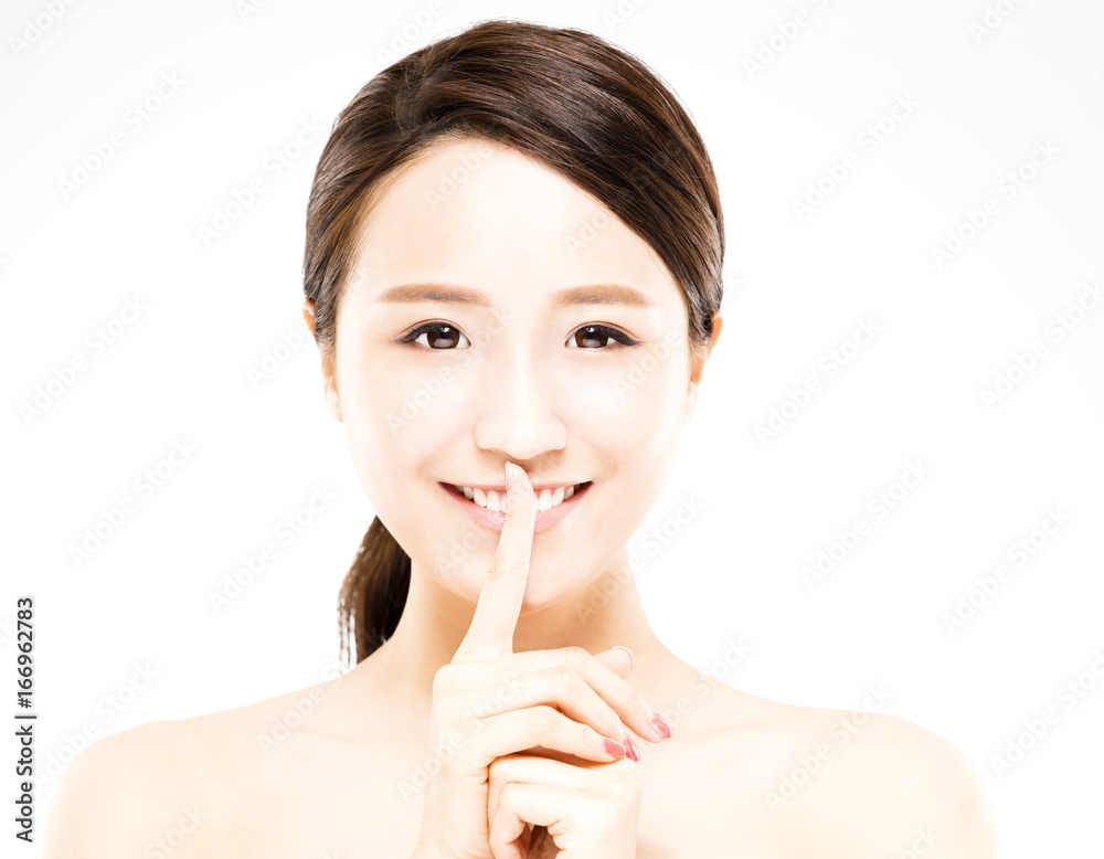 closeup beautiful young woman with silent gesture closeup beautiful young woman with silent gesture