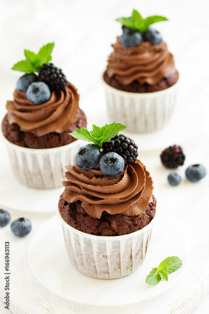Chocolate cupcakes, with chocolate cream and fresh berries. Chocolate cupcakes, with chocolate cream and fresh berries.