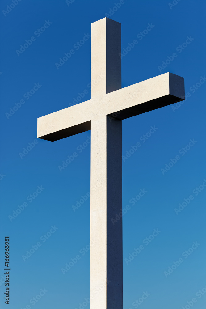 Cross as a symbol of Christianity with blue sky on background