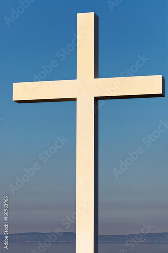 Cross as a symbol of Christianity with clear blue sky on background
