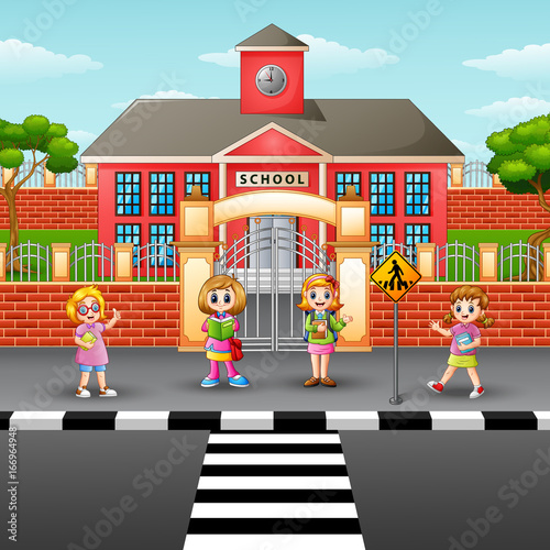 Fototapeta Naklejka Na Ścianę i Meble -  Children crossing the street in front school