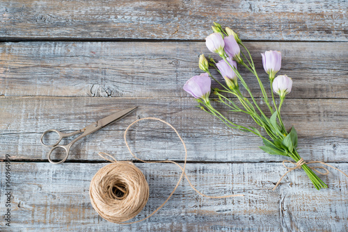 Eustoma flowers on wooden background. Floral background