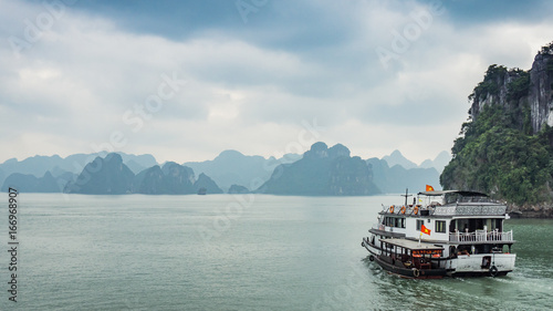 Cruise boat near rock islands in Halong Bay, Vietnam, Southeast Asia