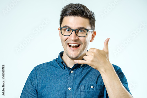 Bild auf Leinwand Call me! Handsome young man showing call me sign