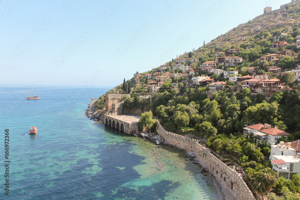 City on the mountain by the sea with the ship, Turkey, Alanya