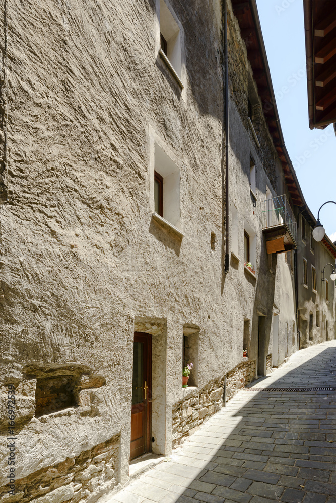 old houses on bending street in medieval village of Bard, Italy