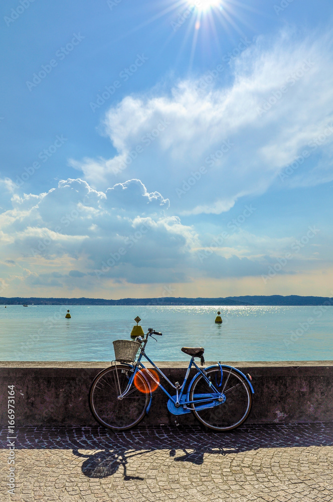 Fototapeta premium italian bike on wall in sunny day in small town italy on lake garda