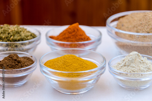 Different kind of colorful spices powder in glass bowls. Food and cuisine additives.