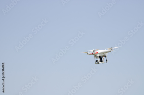 Small drone flying outdoors, technology concepts, copy space photo