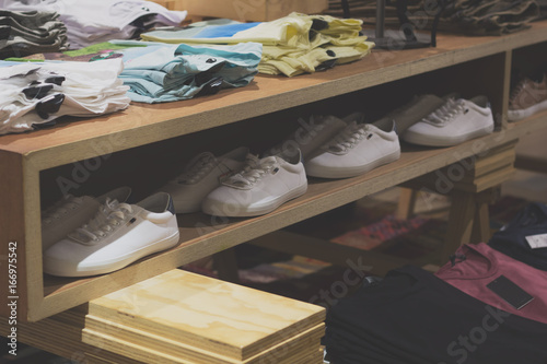 sneakers row on the shelf in a trendy clothing store.