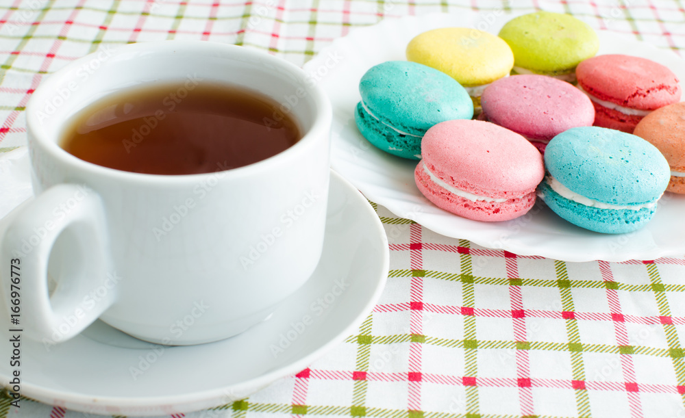 Cup of tea and a cake and macaroon Cup of tea and a cake and macaroon