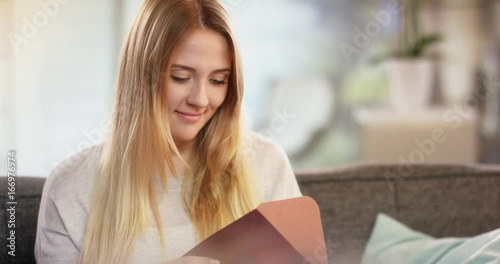 Young attractive caucasian woman receiving letter and smiling for joy