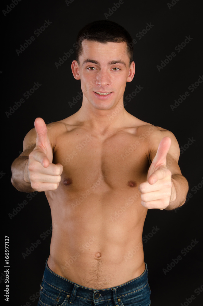 Fototapeta premium A handsome funny guy. Black background. Studio. 