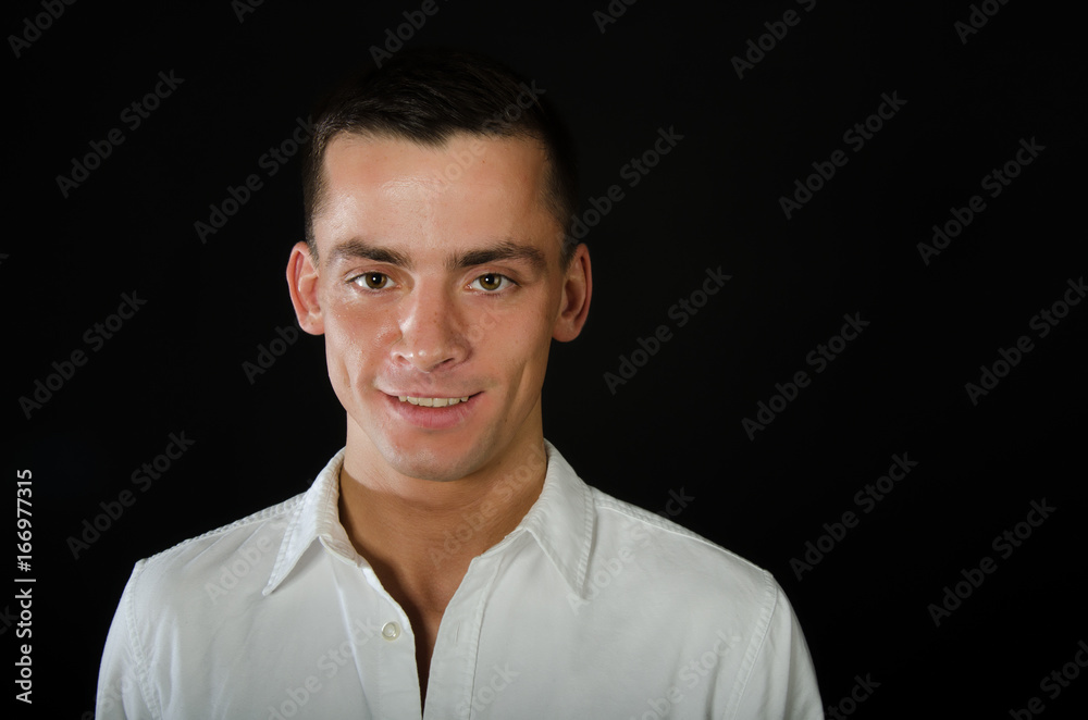 Okay. Good news. Young attractive guy. Black background. Studio.