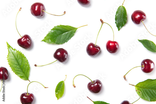 Ripe cherry berries and cherry leaves pattern isolated on white background, top view