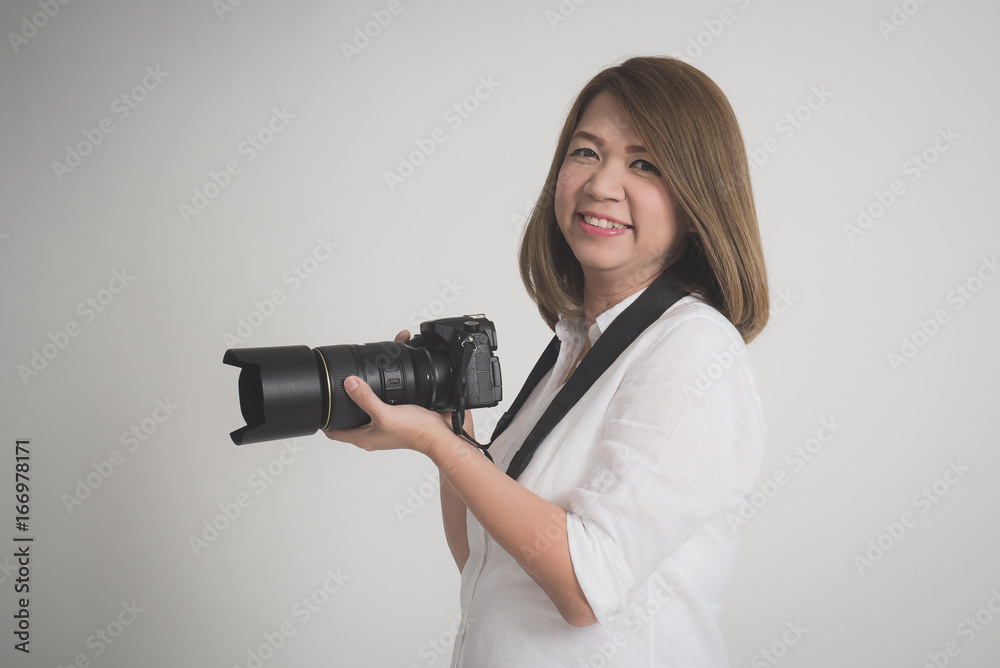 woman holding camera on gray background woman holding camera on gray background