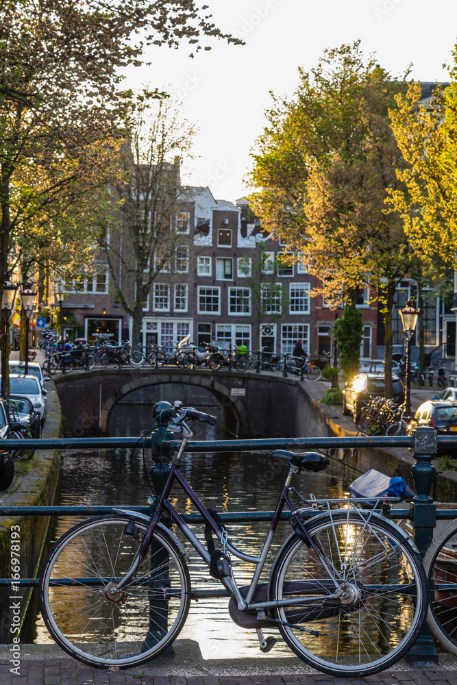 Bicycles and boats at  streets of Amsterdam in autumn
