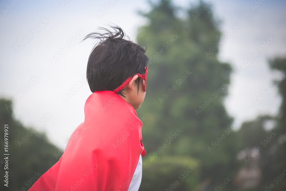 Asian child in in Superhero's costume playing Asian child in in Superhero's costume playing