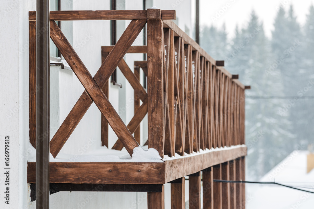 Snow-covered wooden balustrade in winter in the mountains, shallow DOF Snow-covered wooden balustrade in winter in the mountains, shallow DOF