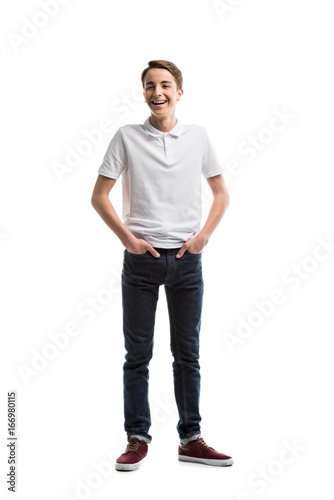 happy caucasian teenager in casual clothing with hands in pockets isolated on white © LIGHTFIELD STUDIOS