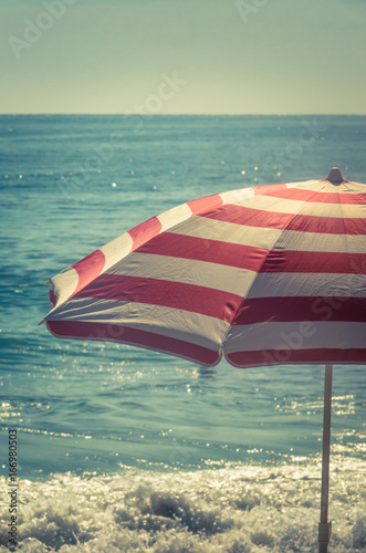 Striped Beach Umbrella With Blue Sea