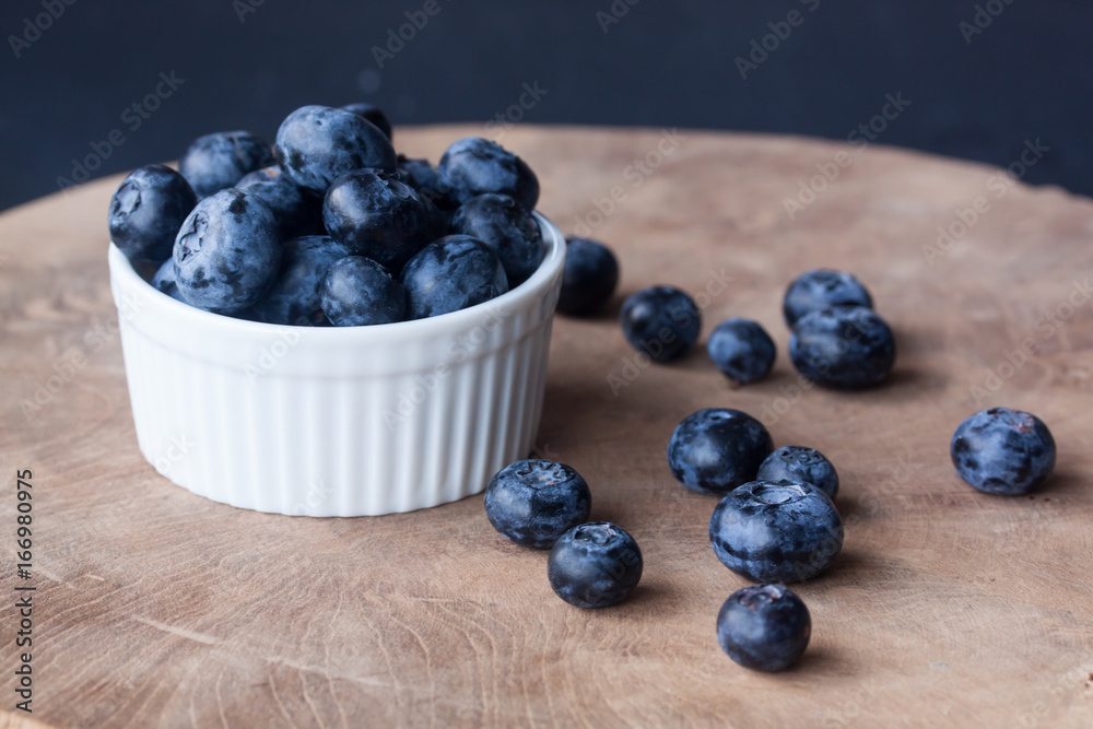 Blueberry in a bowl on a wood background Blueberry in a bowl on a wood background