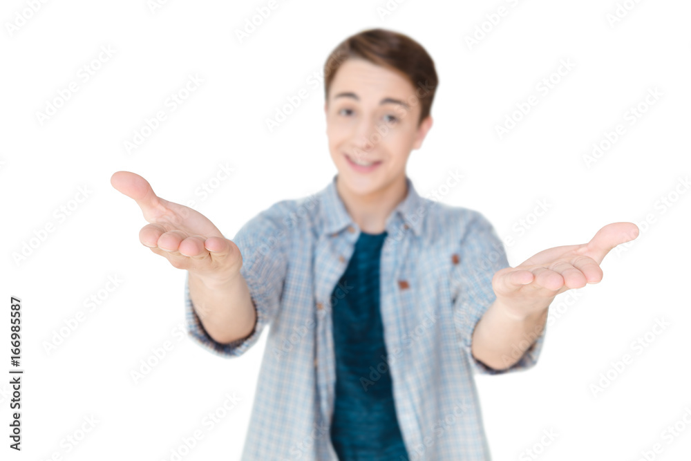 selective focus of smiling caucasian teenager with outstretched arms looking at camera isolated on white selective focus of smiling caucasian teenager with outstretched arms looking at camera isolated on white