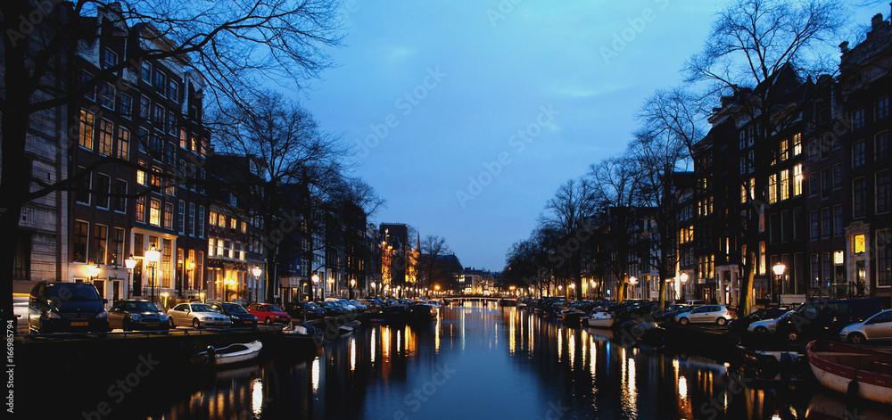 Amsterdam canal and buildings at night
