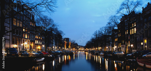 Amsterdam canal and buildings at night