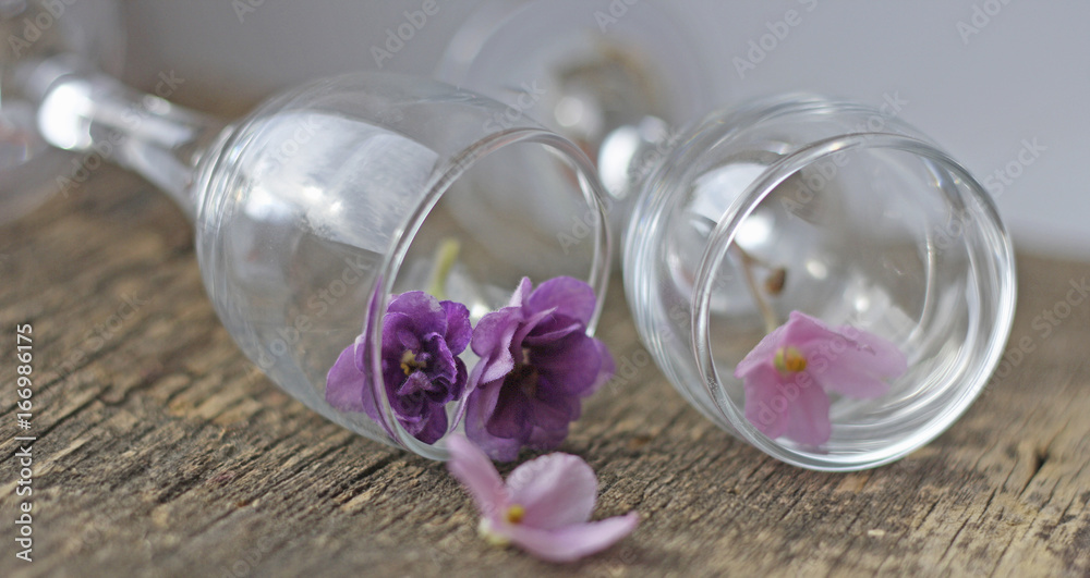 A romantic arrangement of flowers and glasses.