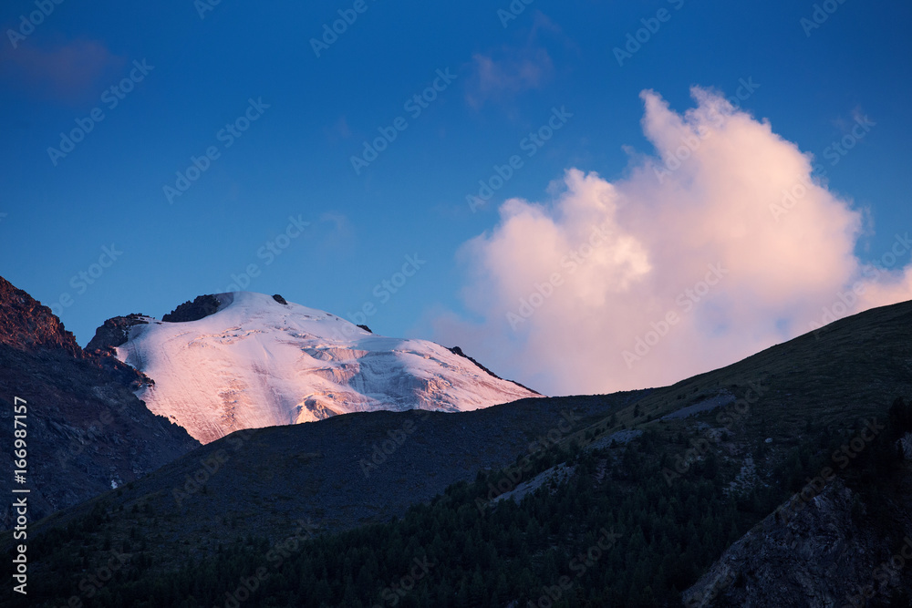 Mountain peak with glacier at sunset