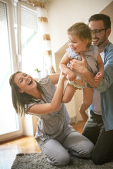 Happy family spending time with their little baby.