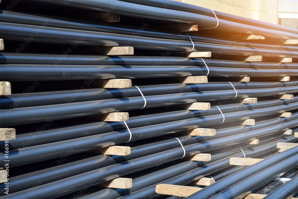 Plastic pipes in stock of finished products stacked in packs Plastic pipes in stock of finished products stacked in packs