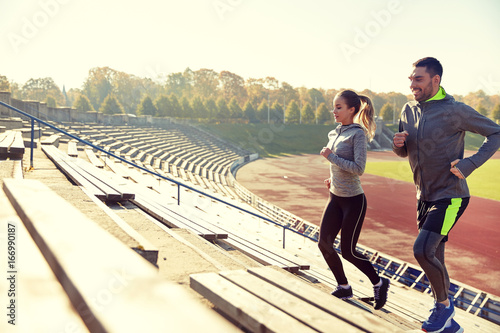 happy couple running upstairs on stadium