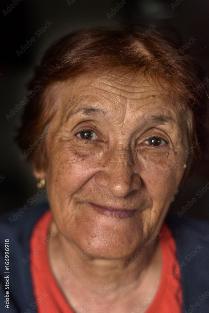 Portrait of an elderly woman on a dark background