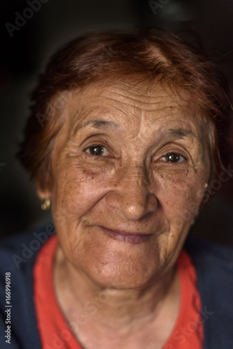 Portrait of an elderly woman on a dark background