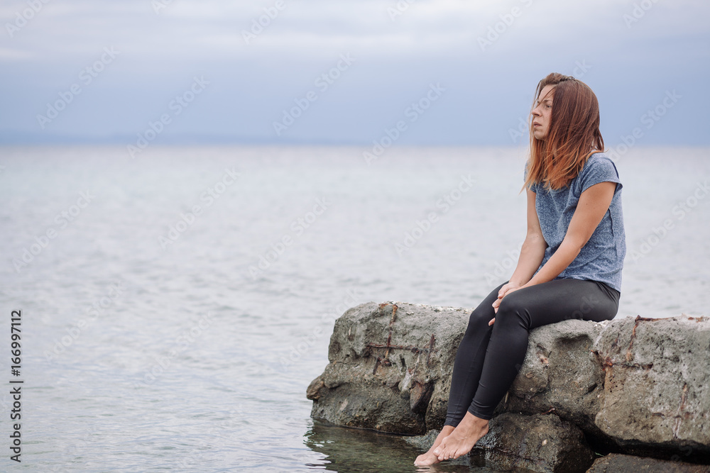 Woman alone and depressed at seaside